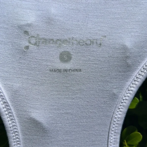 Orangetheory white tank with gold lettering and open slit in back - Picture 3 of 9